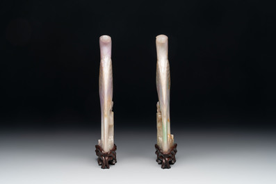 A pair of Chinese lavender and emerald-green jadeite parrots on wooden stands, 19th C.