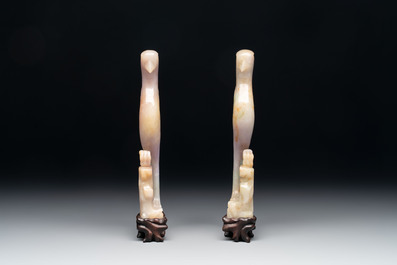 A pair of Chinese lavender and emerald-green jadeite parrots on wooden stands, 19th C.