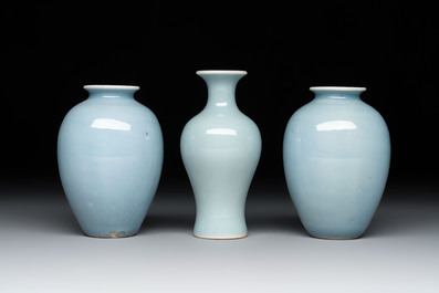Three Chinese claire-de-lune vases on wooden stands, Kangxi mark, 19th C.