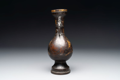 A Chinese parcel-gilt bronze vase with dragon-form handles, Yuan/Ming