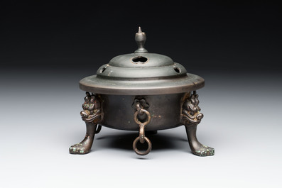 A Chinese bronze tripod censer and cover, Sui/Tang