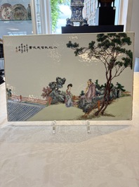 A Chinese famille rose plaque with a sage and a lady in a garden, signed Huang Can 黃燦, Republic