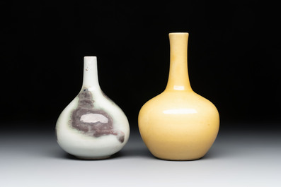 A Chinese copper-red 'mythical beasts' vase and a yellow-glazed bottle vase, with two wooden stands, Kangxi and later
