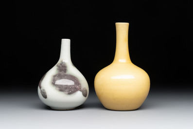 A Chinese copper-red 'mythical beasts' vase and a yellow-glazed bottle vase, with two wooden stands, Kangxi and later