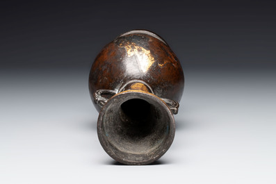 A Chinese parcel-gilt bronze vase with dragon-form handles, Yuan/Ming