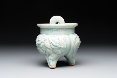 A Chinese qingbai tripod censer with floral relief design, Song/Yuan