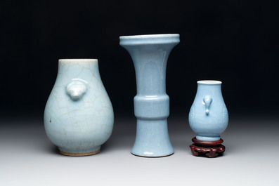 Three Chinese claire-de-lune vases, one with a wooden stand, Yongzheng mark, 19/20th C.