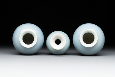 Three Chinese claire-de-lune vases on wooden stands, Kangxi mark, 19th C.