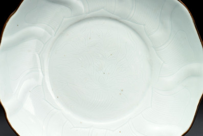 A Chinese moulded white-glazed plate with anhua floral design, Xuande mark, Ming