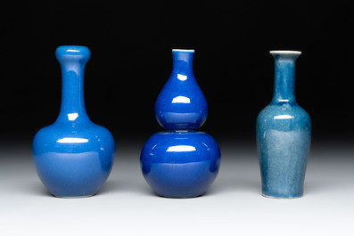 Three Chinese blue-glazed miniature vases on wooden stands and a claire-de-lune seal paste box and cover, 19th C.