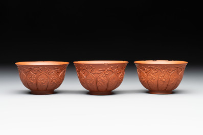A set of five Chinese Yixing stoneware cups with floral design, Kangxi
