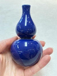 Three Chinese blue-glazed miniature vases on wooden stands and a claire-de-lune seal paste box and cover, 19th C.