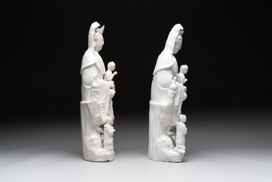 A pair of Chinese Dehua blanc de Chine groups of Guanyin with a child and servants, 18th C.