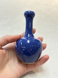 Three Chinese blue-glazed miniature vases on wooden stands and a claire-de-lune seal paste box and cover, 19th C.