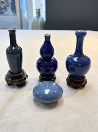 Three Chinese blue-glazed miniature vases on wooden stands and a claire-de-lune seal paste box and cover, 19th C.