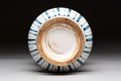 A pair of Spanish splashed blue pottery albarelli and an Italian blue, white and manganese albarello, Savona, 17/18th C.