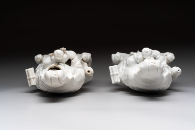A pair of Chinese Dehua blanc de Chine groups of Guanyin with a child and servants, 18th C.