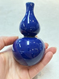 Three Chinese blue-glazed miniature vases on wooden stands and a claire-de-lune seal paste box and cover, 19th C.