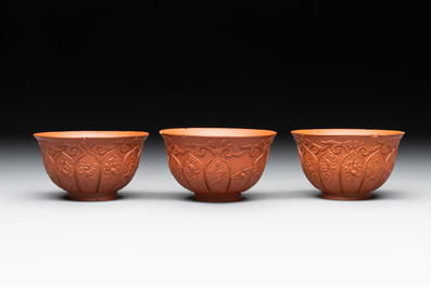 A set of five Chinese Yixing stoneware cups with floral design, Kangxi