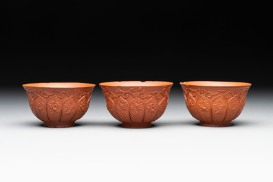 A set of five Chinese Yixing stoneware cups with floral design, Kangxi