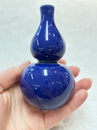 Three Chinese blue-glazed miniature vases on wooden stands and a claire-de-lune seal paste box and cover, 19th C.