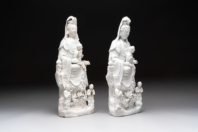A pair of Chinese Dehua blanc de Chine groups of Guanyin with a child and servants, 18th C.