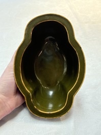 A fine Chinese teadust-glazed quadrifoil jardini&egrave;re with an openworked wooden stand, Yongzheng mark and of the period