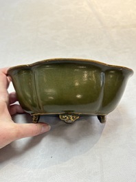 A fine Chinese teadust-glazed quadrifoil jardini&egrave;re with an openworked wooden stand, Yongzheng mark and of the period