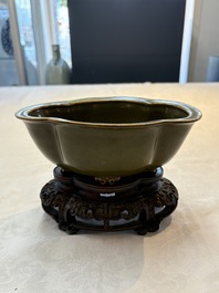 A fine Chinese teadust-glazed quadrifoil jardini&egrave;re with an openworked wooden stand, Yongzheng mark and of the period