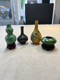 Four Chinese monochrome wares and two wooden stands, 19th C.