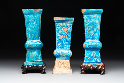 Three Chinese turquoise-glazed 'gu' vases with floral design, two with wooden stands, Ming