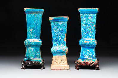 Three Chinese turquoise-glazed 'gu' vases with floral design, two with wooden stands, Ming