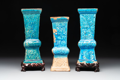 Three Chinese turquoise-glazed 'gu' vases with floral design, two with wooden stands, Ming