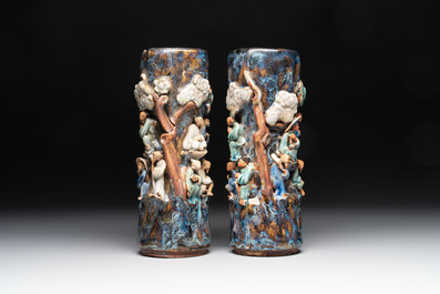 A pair of Chinese Shiwan polychrome hat stands with haut-relief figural design, 19/20th C.