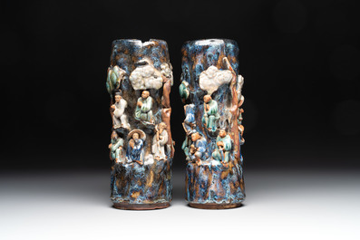 A pair of Chinese Shiwan polychrome hat stands with haut-relief figural design, 19/20th C.