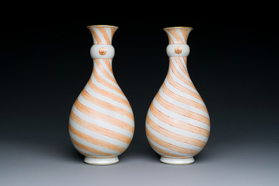 A rare pair of Chinese pear-shaped bottle vases with iron-red swirls, Kangxi