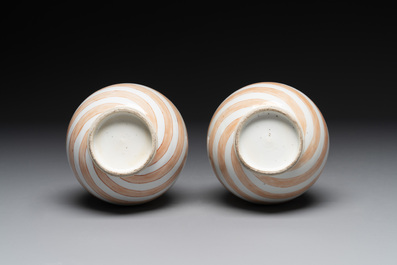 A rare pair of Chinese pear-shaped bottle vases with iron-red swirls, Kangxi