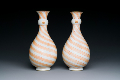 A rare pair of Chinese pear-shaped bottle vases with iron-red swirls, Kangxi