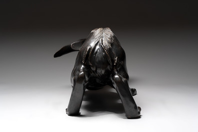A large Japanese bronze sculpture of a reclining hare, 20th C.
