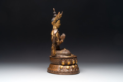 A Tibetan or Nepalese turquoise-inlaid partly-gilt bronze figure of White Tara, 20th C.
