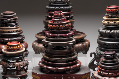 A collection of 70 Chinese wooden stands and covers, 19/20th C.