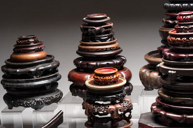 A collection of 70 Chinese wooden stands and covers, 19/20th C.