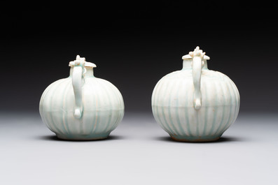 A pair of Chinese qingbai ewers and covers with dragon-form handles, Song/Yuan