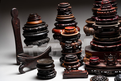 A collection of 70 Chinese wooden stands and covers, 19/20th C.