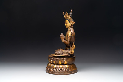 A Tibetan or Nepalese turquoise-inlaid partly-gilt bronze figure of White Tara, 20th C.