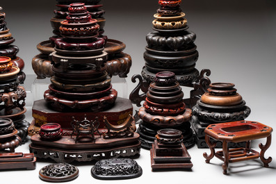 A collection of 70 Chinese wooden stands and covers, 19/20th C.