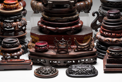 A collection of 70 Chinese wooden stands and covers, 19/20th C.