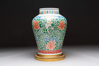A Chinese wucai 'He He Er Xian' vase on gilt-bronze stand, 19th C.