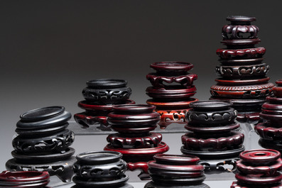 A collection of 80 Chinese wooden stands, 19/20th C.