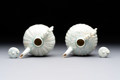 A pair of Chinese qingbai ewers and covers with dragon-form handles, Song/Yuan